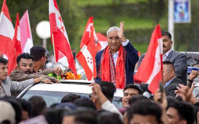 Former Nepal premier Deuba returns home, faces graft probe Former Nepal premier Deuba returns home, faces graft probe
